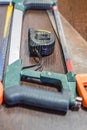 Handsaws and measuring tape on wooden background Royalty Free Stock Photo