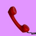 Handset of authentic red retro rotary telephone isolated on pink Royalty Free Stock Photo