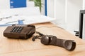 handset of black stationary telephone on table Royalty Free Stock Photo