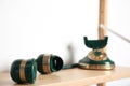 Handset and green vintage corded phone on wooden shelf near white wall, closeup Royalty Free Stock Photo