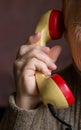 The handset is in the hand of an old woman. Royalty Free Stock Photo