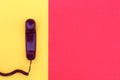 The handset lies on yellow and red colors. Royalty Free Stock Photo