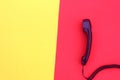 The handset lies on yellow and red colors. Royalty Free Stock Photo