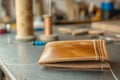 handsewing a leather wallet with waxed thread on a table Royalty Free Stock Photo