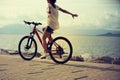 Woman riding a bike on sunny seaside Royalty Free Stock Photo