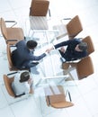 Handshake across the table. Meeting around a boardroom table. Royalty Free Stock Photo