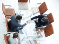 Handshake across the table. Meeting around a boardroom table. Royalty Free Stock Photo