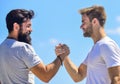 Handshake arm wrestling style. Strong and muscular arms. Successful deal handshake blue sky background. Men shaking Royalty Free Stock Photo