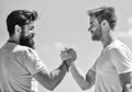 Handshake arm wrestling style. Strong and muscular arms. Successful deal handshake blue sky background. Men shaking Royalty Free Stock Photo