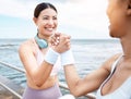 Handshake, beach and happy fitness friends excited with training targets, exercise and workout goals outdoors. Smile