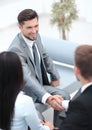 Handshake business partners in the lobby of the office. Royalty Free Stock Photo