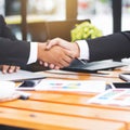 Handshake and business people concept. Two men shaking hands, blurred office background. Royalty Free Stock Photo