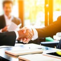 Handshake and business people concept. Two men shaking hands blurred office background. Royalty Free Stock Photo