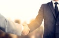 Handshake and business people concept. Two men shaking hands over sunny sity background. Partnership Royalty Free Stock Photo