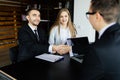 Handshake of businessmen in modern office. Royalty Free Stock Photo