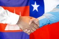 Handshake on Cambodia and Chile flag background. Support concept