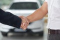 Handshake close up in car dealership. Royalty Free Stock Photo
