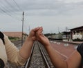 Handshake conveys good friendship in the train station background.