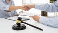 Handshake after cooperation between attorneys lawyer and clients after consultation discussing a contract agreement customer at