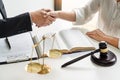 Handshake after cooperation between attorneys lawyer and clients discussing a contract agreement hope of victory over legal