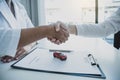 Handshake of cooperation customer and salesman after signed the contract agreement, successful car loan buying, or vehicle rental Royalty Free Stock Photo
