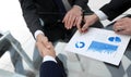 Handshake of financial partners at the Desk