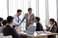 Handshake between the foreign CEO and the Asian manager who can successfully complete the project which makes the company gain