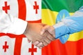 Handshake on Georgia and Ethiopia flag background