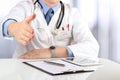 Handshake Gesture from Doctor in a white labcoat and stethoscope Royalty Free Stock Photo