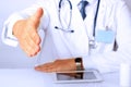 Handshake Gesture from Doctor in a white labcoat and stethoscope on his sholder