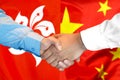 Handshake on Hong Kong and China flag background Royalty Free Stock Photo