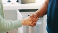 Handshake, kitchen and closeup with man, woman and agreement for plumbing services in home. Shaking hands, plumber and Royalty Free Stock Photo