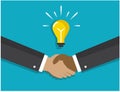 A handshake and a light bulb symbolizes the idea Royalty Free Stock Photo