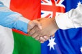 Handshake on Madagascar and Australia flag background. Support concept