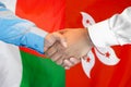 Handshake on Madagascar and Hong Kong flag background. Support concept Royalty Free Stock Photo