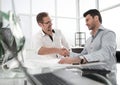 Handshake Manager and client near the table Royalty Free Stock Photo