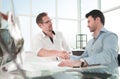 Handshake Manager and client near the table Royalty Free Stock Photo