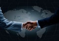 Handshake with map of the world in background. Royalty Free Stock Photo