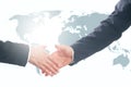 Handshake with map of the world in background Royalty Free Stock Photo