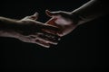 Handshake. Men holding hands isolated on black. Connection and human relations. Male hands rescue. Friendly handshake Royalty Free Stock Photo