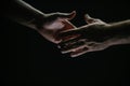 Handshake. Men holding hands isolated on black. Connection and human relations. Male hands rescue. Friendly handshake Royalty Free Stock Photo