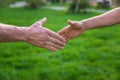 Handshake of men at a meeting in the park. Selective focus. Royalty Free Stock Photo