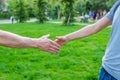 Handshake of men at a meeting in the park. Selective focus. Royalty Free Stock Photo