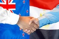 Handshake on New Zealand and Egypt flag background