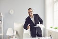 Handshake offering. A businessman offers a handshake while standing in an office. Royalty Free Stock Photo