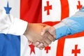 Handshake on Panama and Georgia flag background