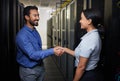 Handshake, partnership or happy people in server room of data center for network help with IT support. B2b deal