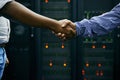 Handshake, partnership or people in server room of data center worker for network help with IT support. Cybersecurity