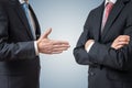 Handshake refuse. Man is refusing shake hand with businessman who is offering his hand. Royalty Free Stock Photo