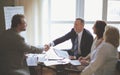 Handshake of senior business partners on the Desk